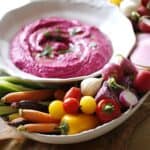Beet Hummus on a Platter with colorful vegetables