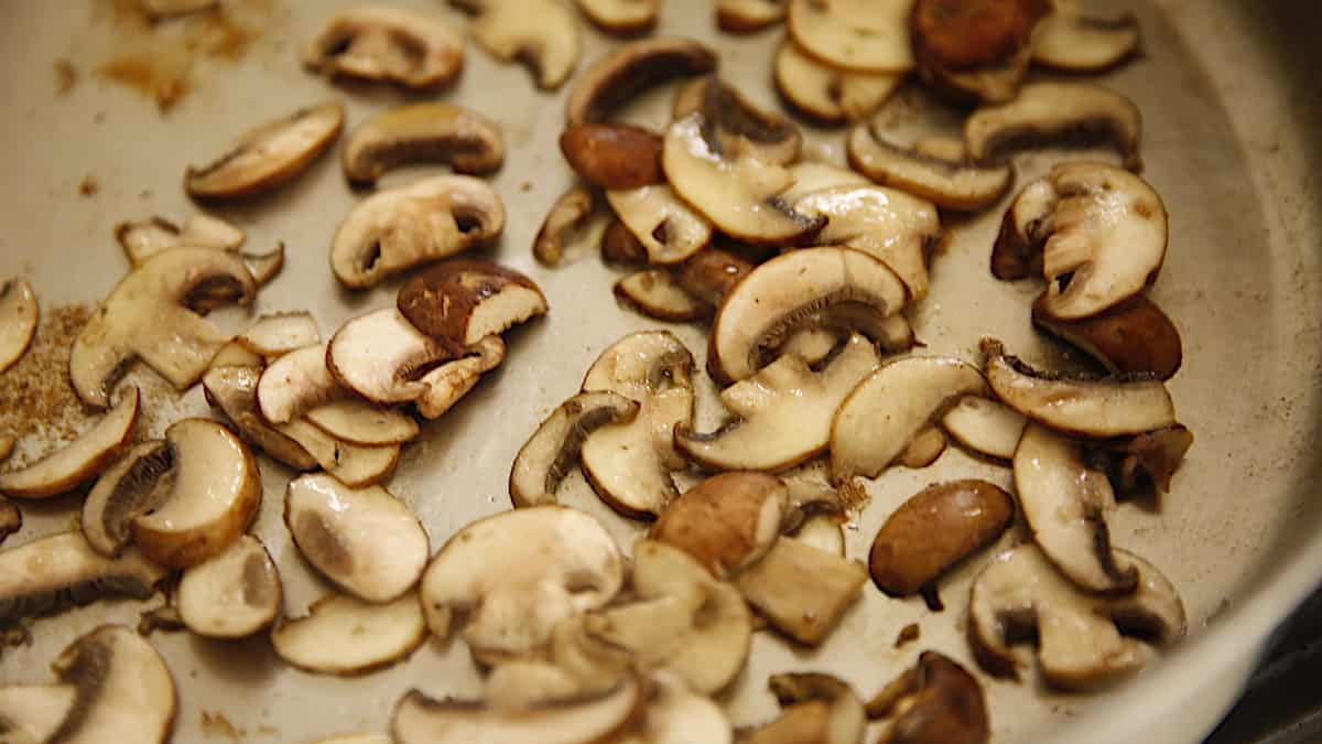 Mushrooms browning in a pan
