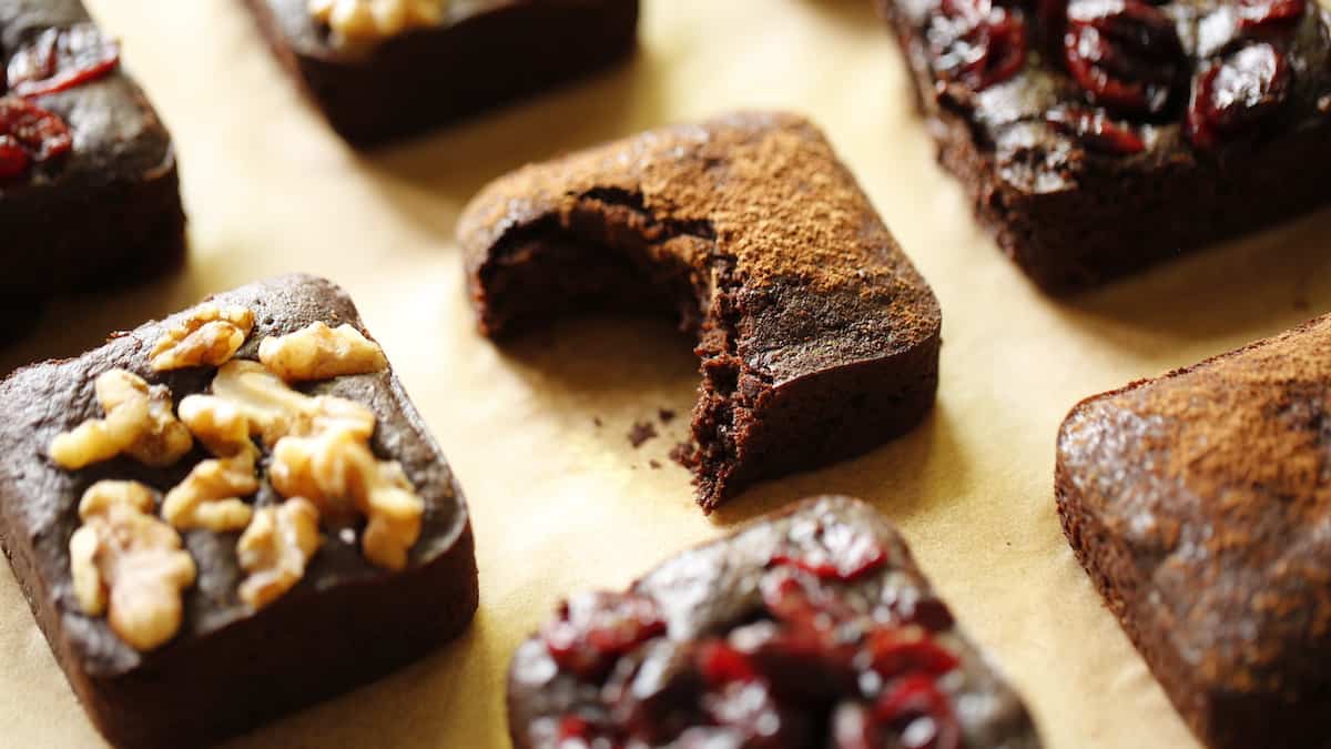 Vegan brownies with walnuts, cranberry and cocoa powder toppings