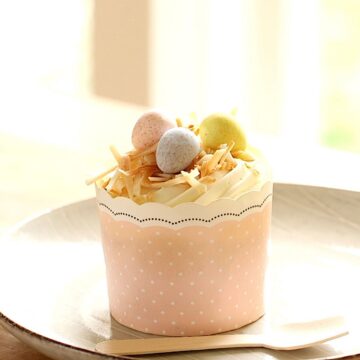 Easter Cupcakes in a Pink Liner with Chocolate eggs and shredded coconut on top