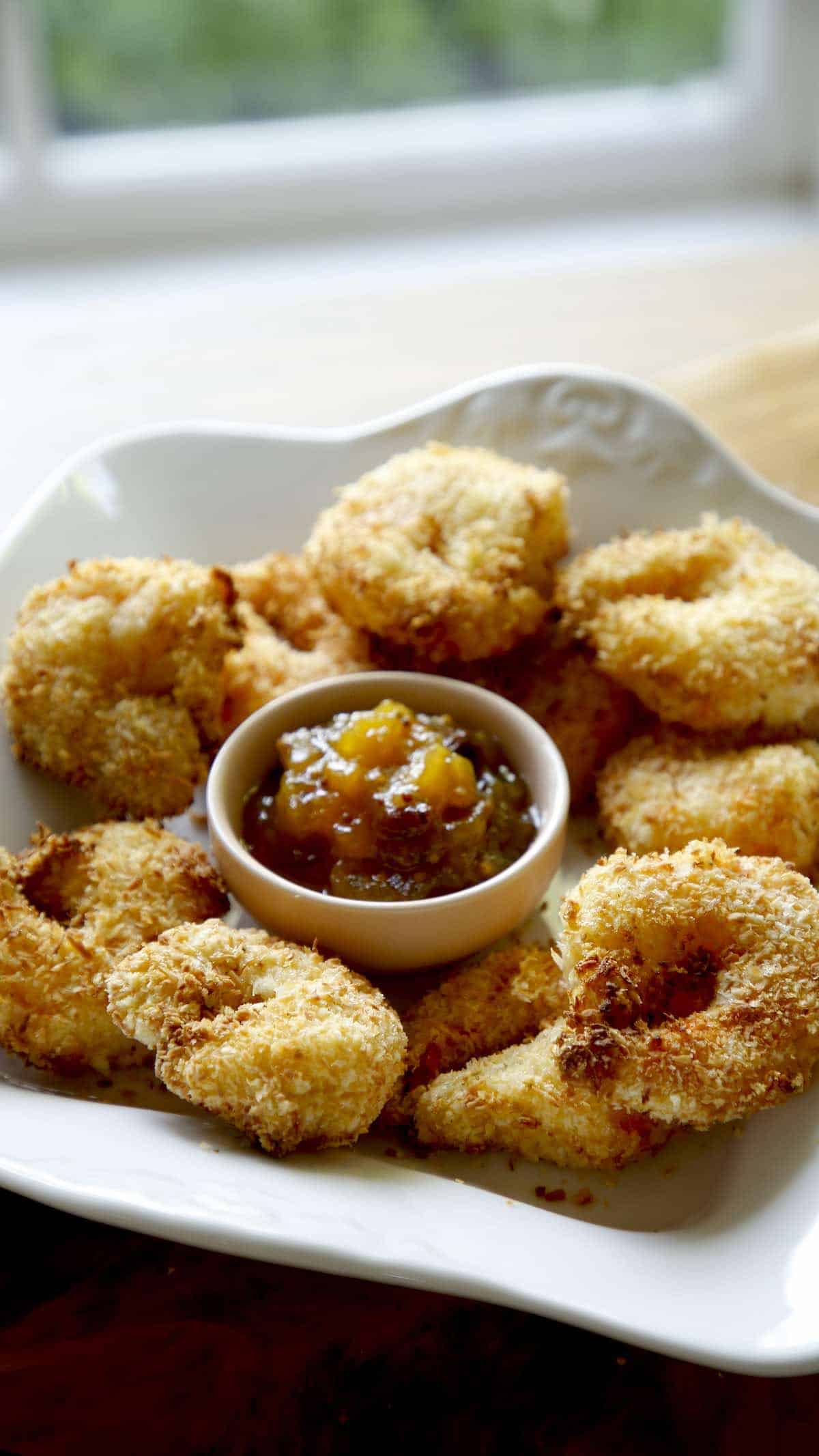 Air Fryer Coconut Shrimp on a white Platter with Mango Chutney