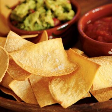 Air Fryer Tortilla Chips on a Platter with Salsa and Guacamole