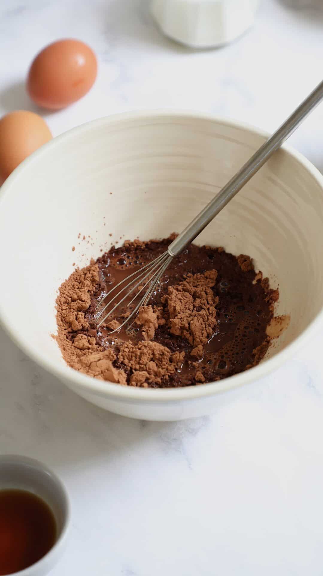 Hot water, chocolate chips and unsweetened cocoa powder in a bowlcocoa 