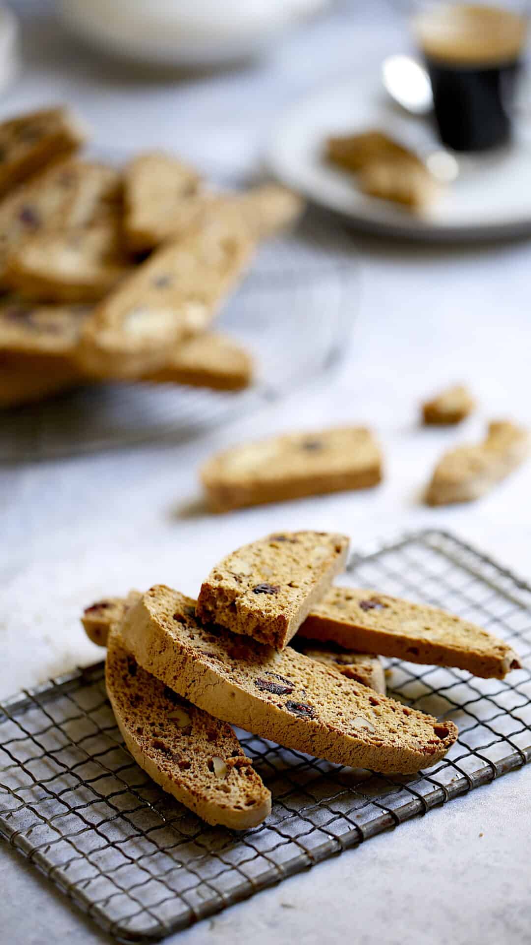 Biscotti Cookie display on cooling racks with a coffee cup in the background