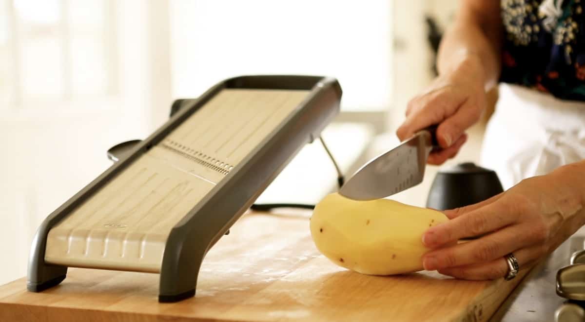 slicing a potato in half