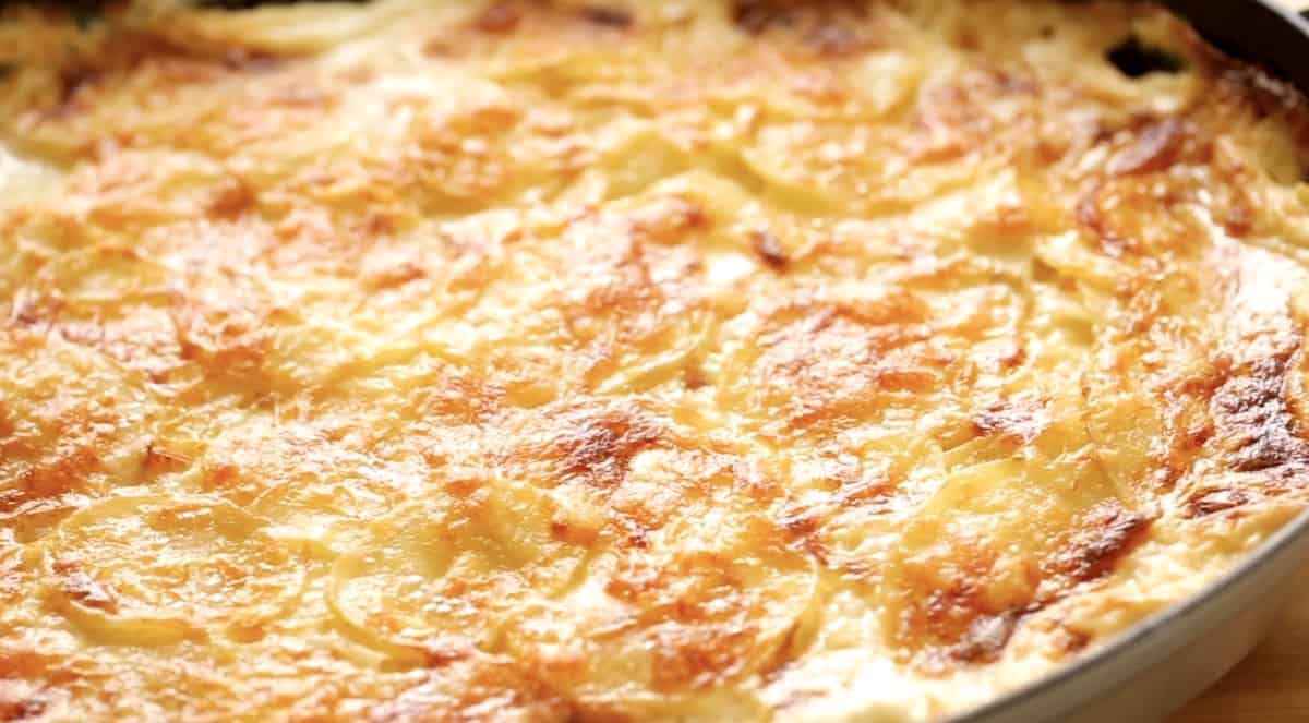 Tight shot of baked cheese on top of potato casserole