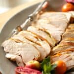 Vertical image of sliced turkey on a platter