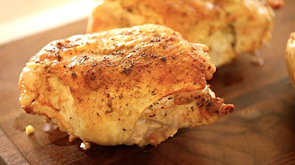 Roasted Turkey Breast with crispy skin on a brown cutting board