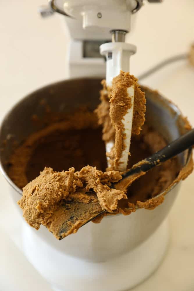 Molasses cookie batter in a stand mixer.