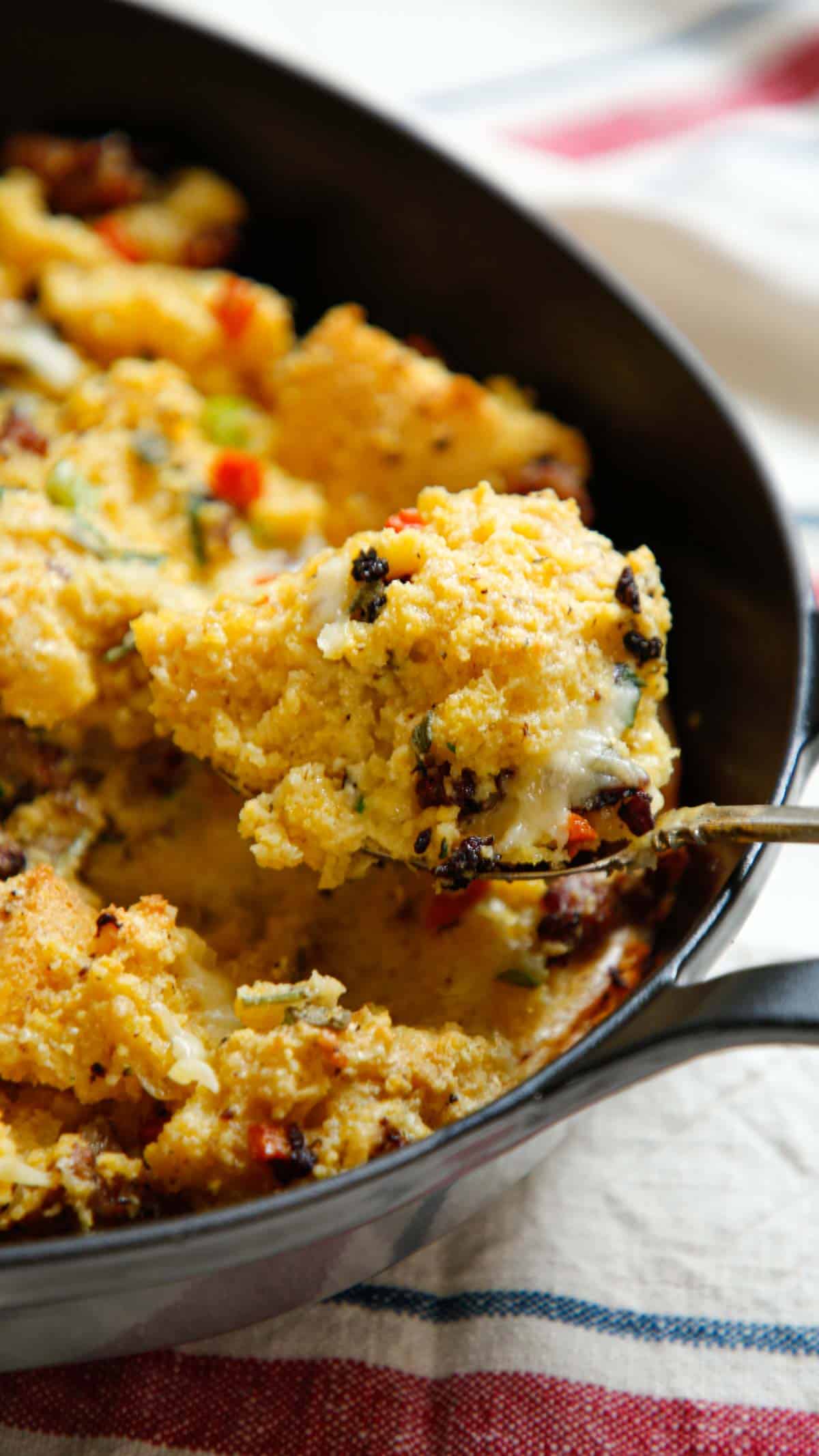 Close up detail of the texture of the stuffing from a serving spoon scooping out a spoonful