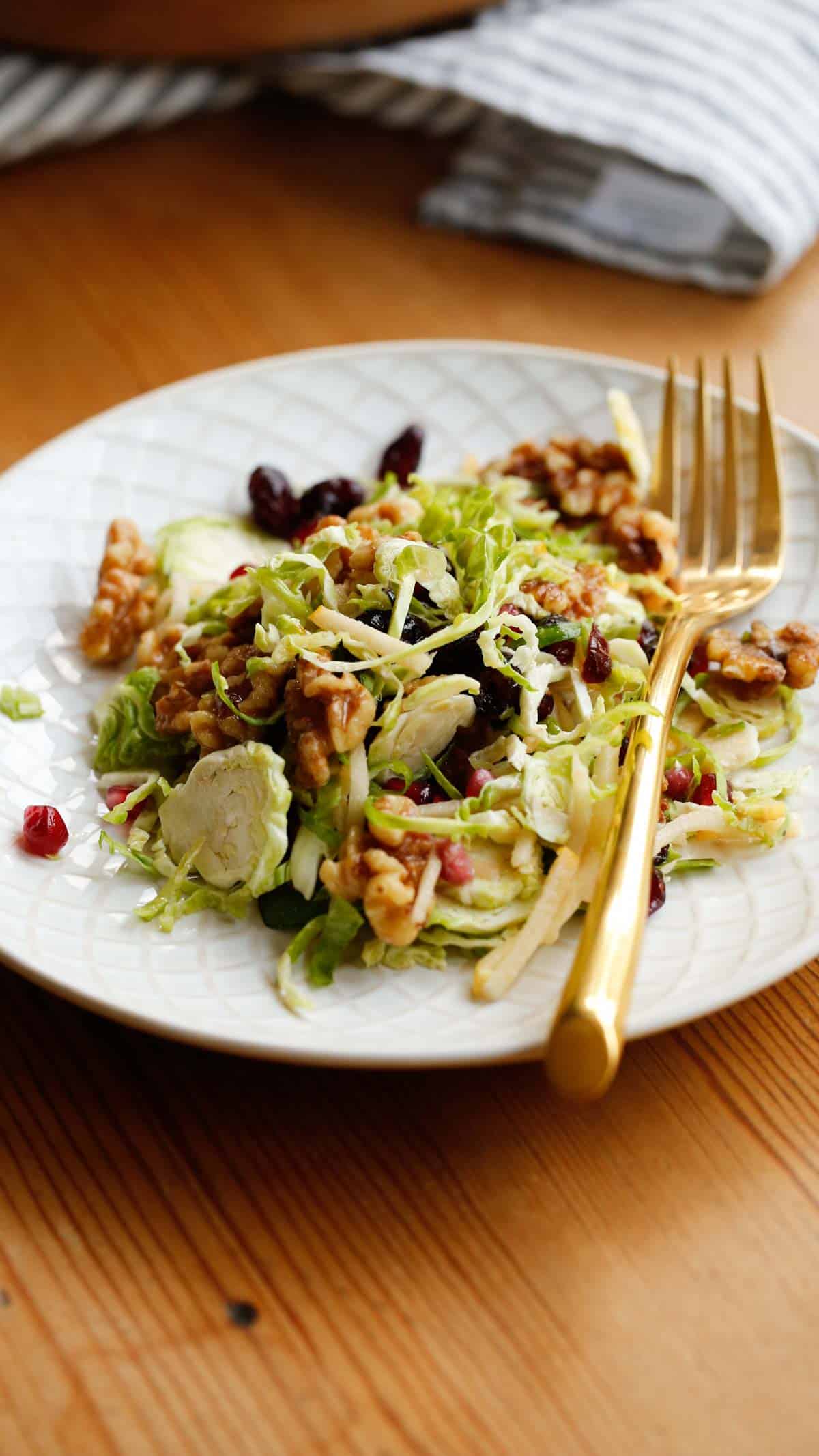 a plate of salad with a gold fork