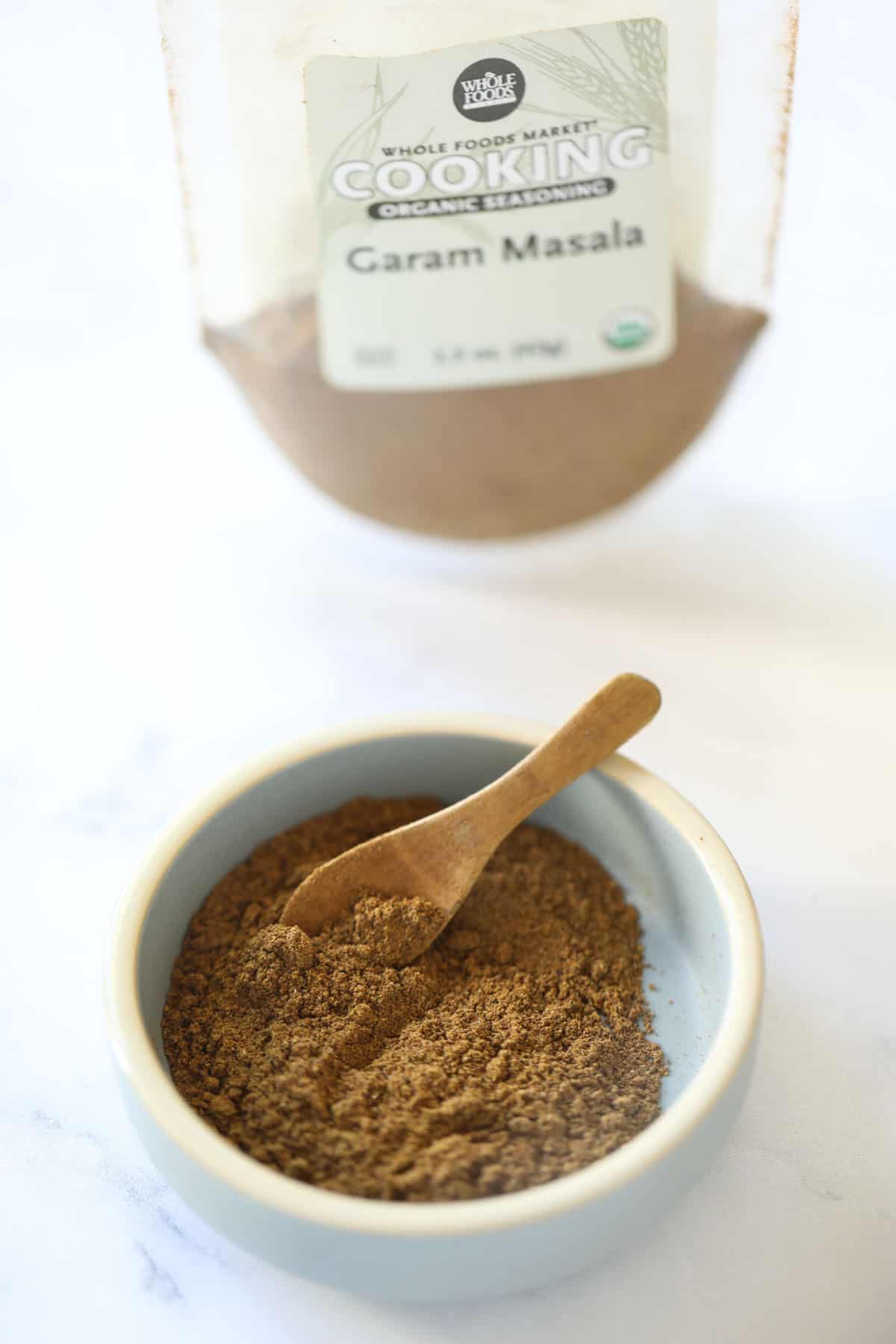 a dish of garam masala spice and spice bag