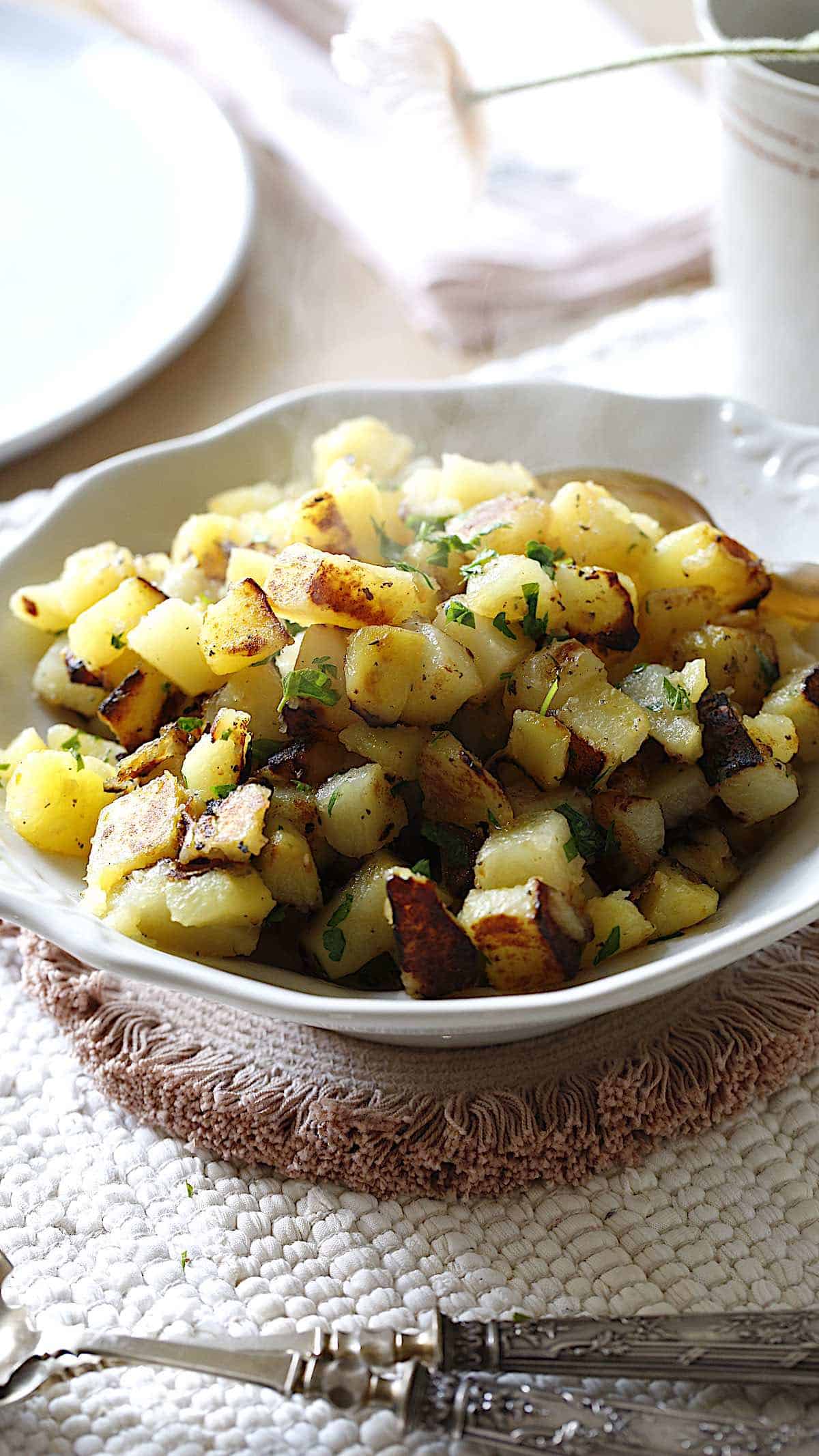 Home FRies in a white bowl on a table