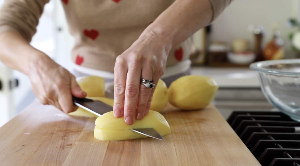 slicing a potato in half