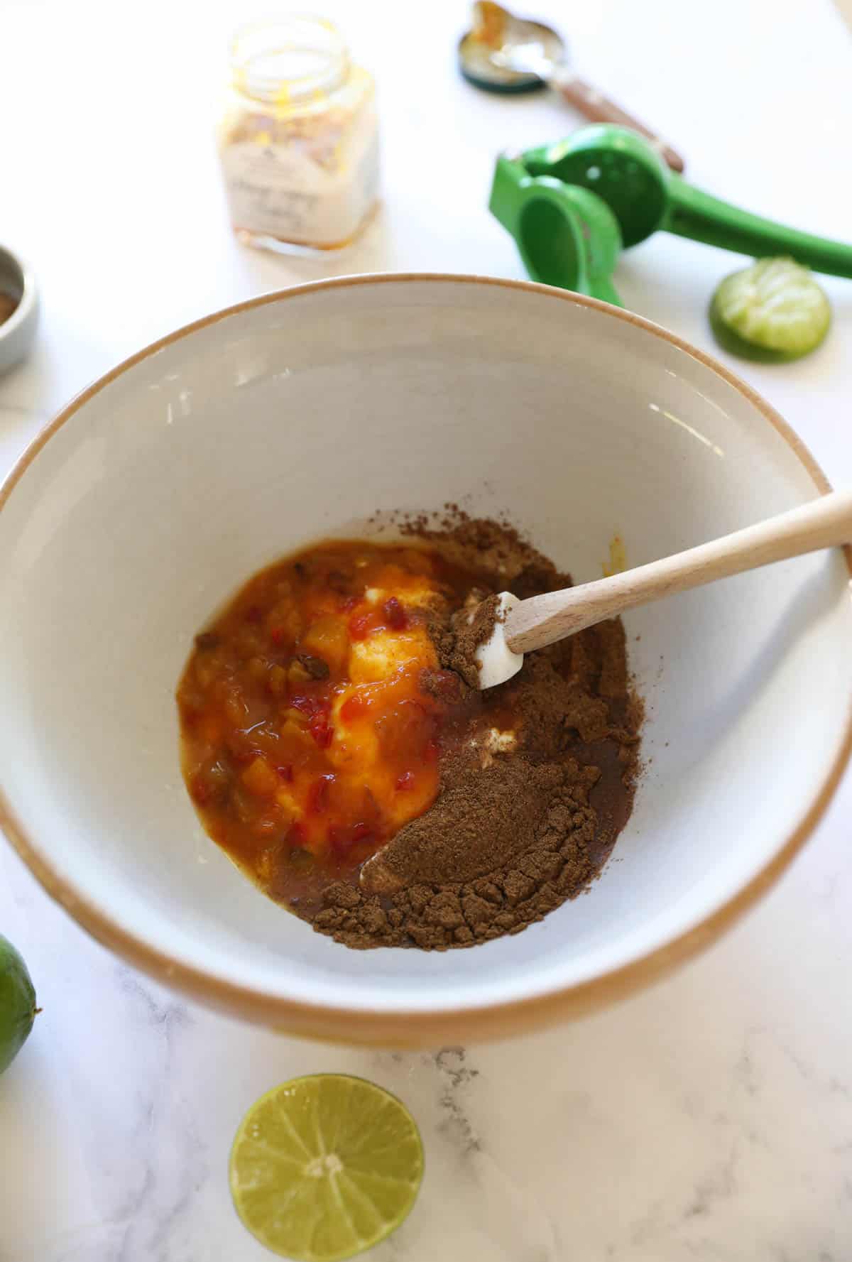 a bowl of greek yogurt and spices added to it