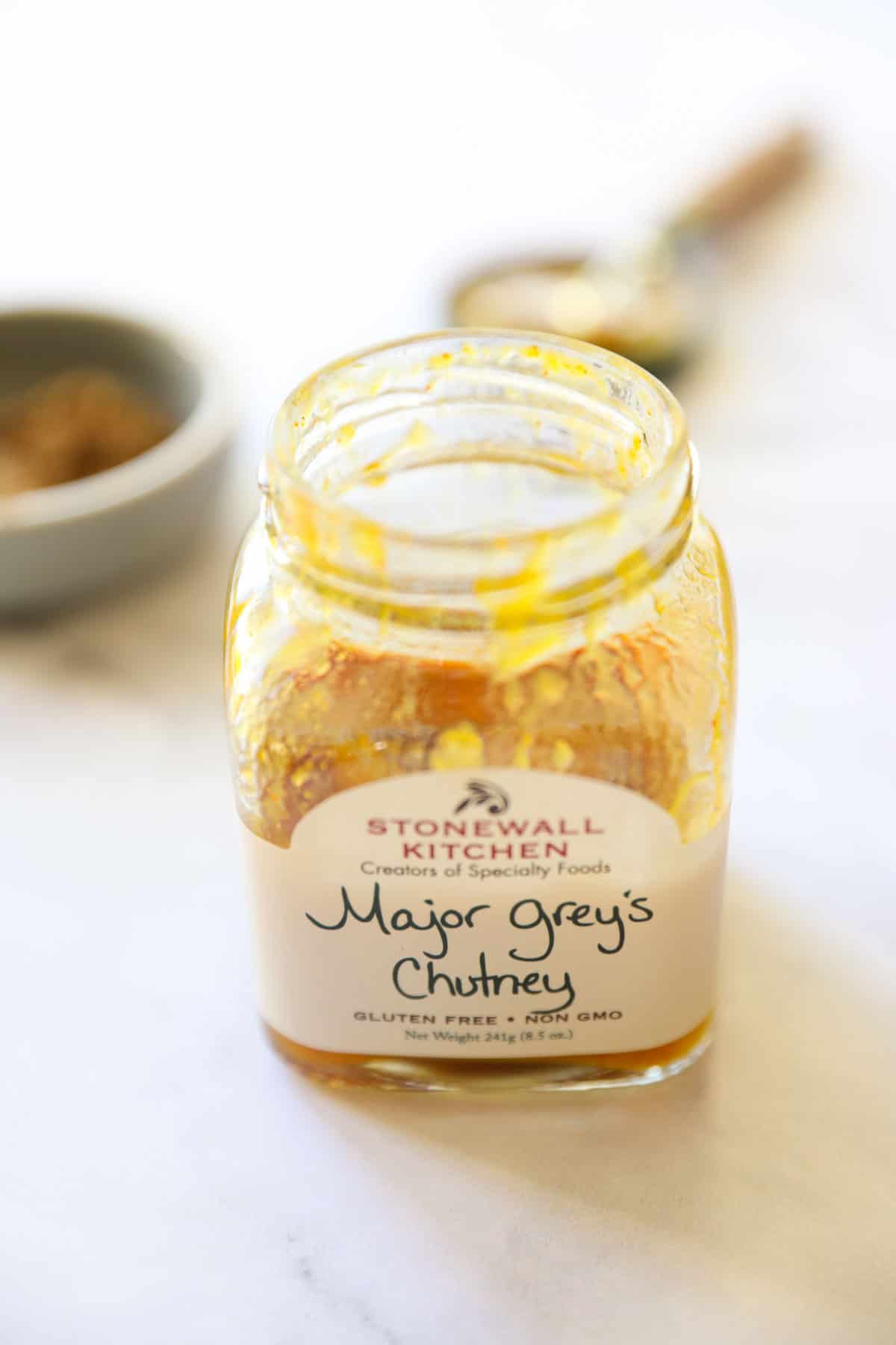 a jar of mango chutney on a counter