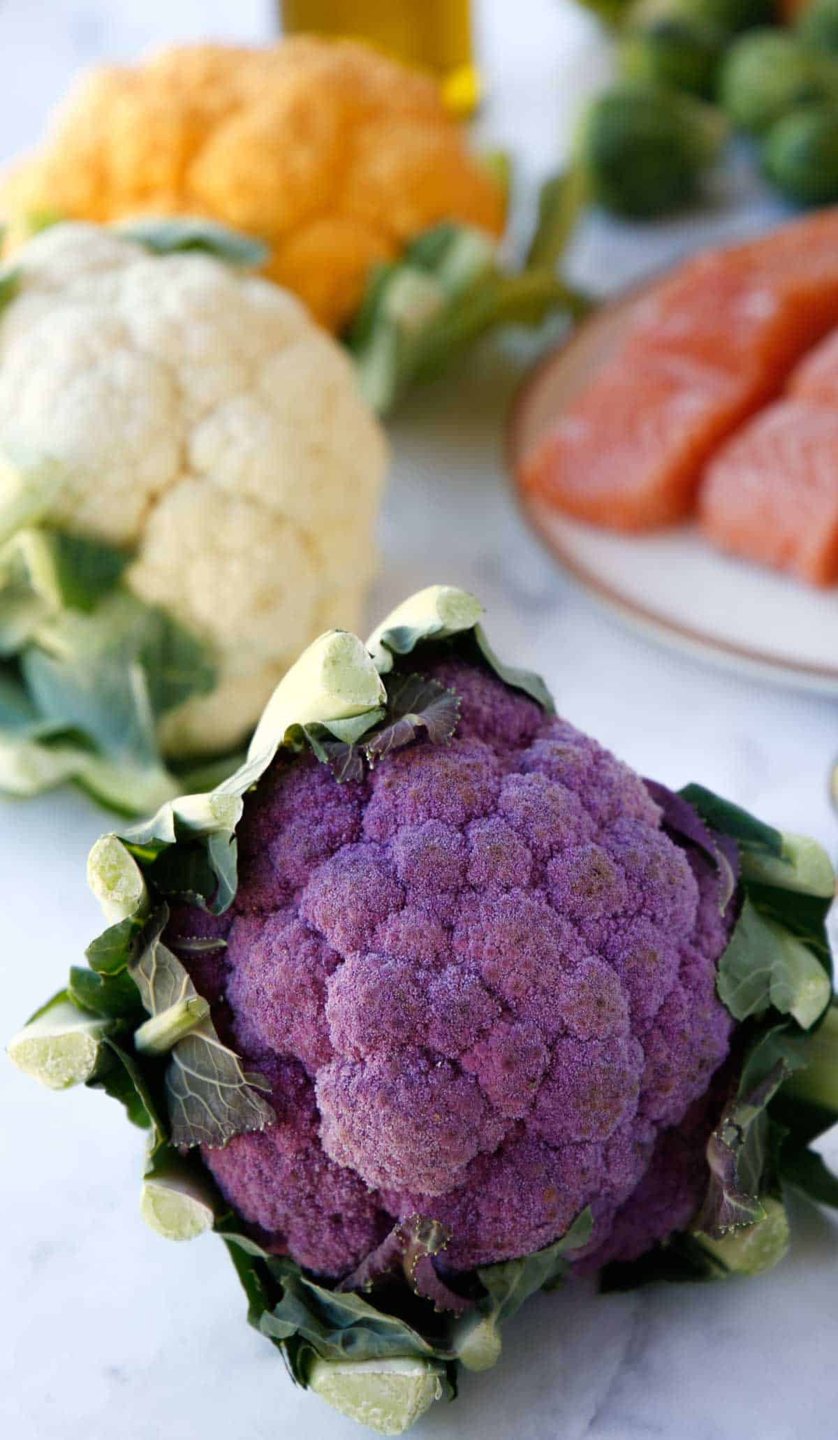 Purple,, White and Orange Cauliflower with Salmon on a Plate