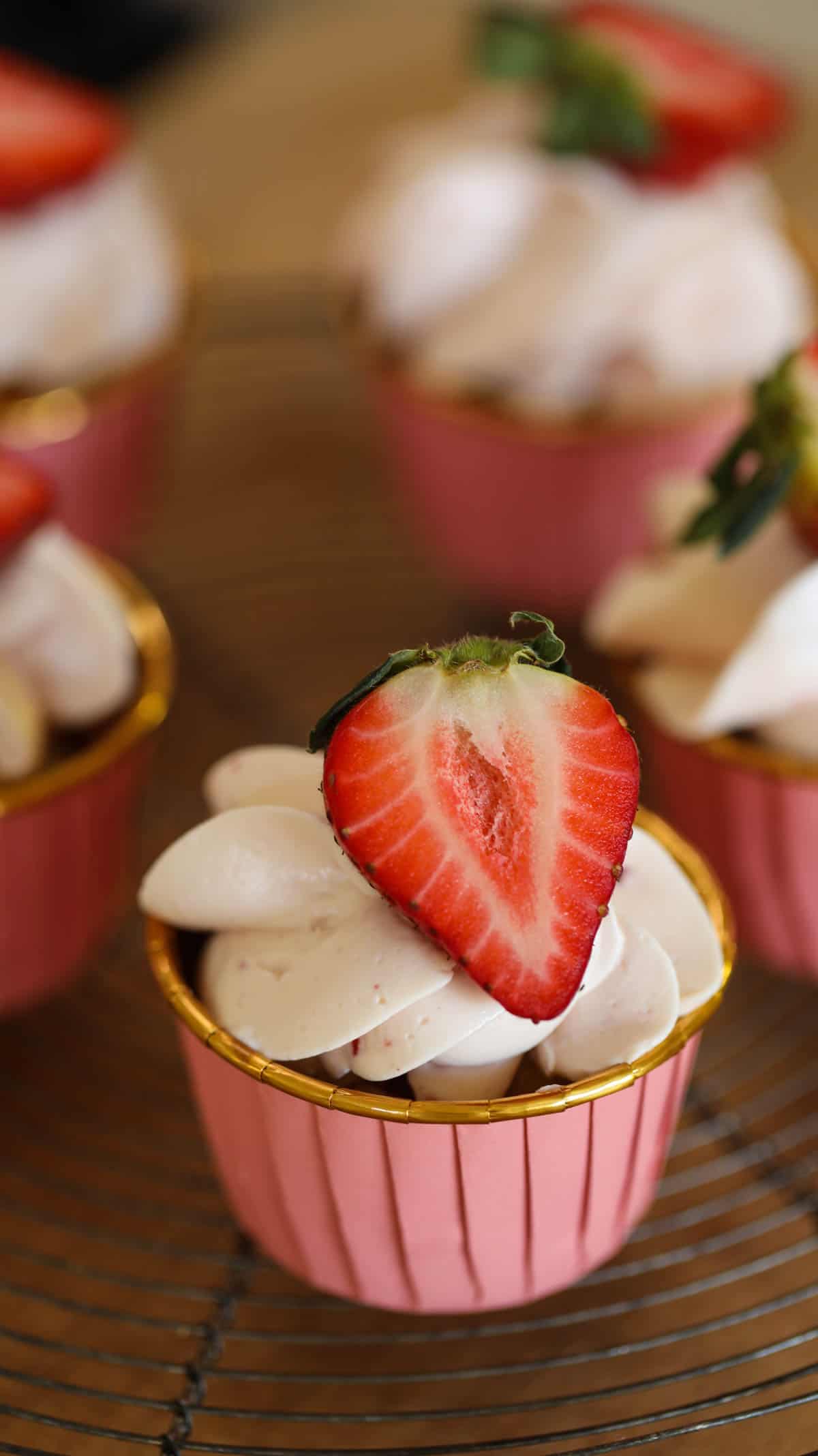 Strawberry Cupcake with Cream CHeese Frosting topped with a fresh strawberry