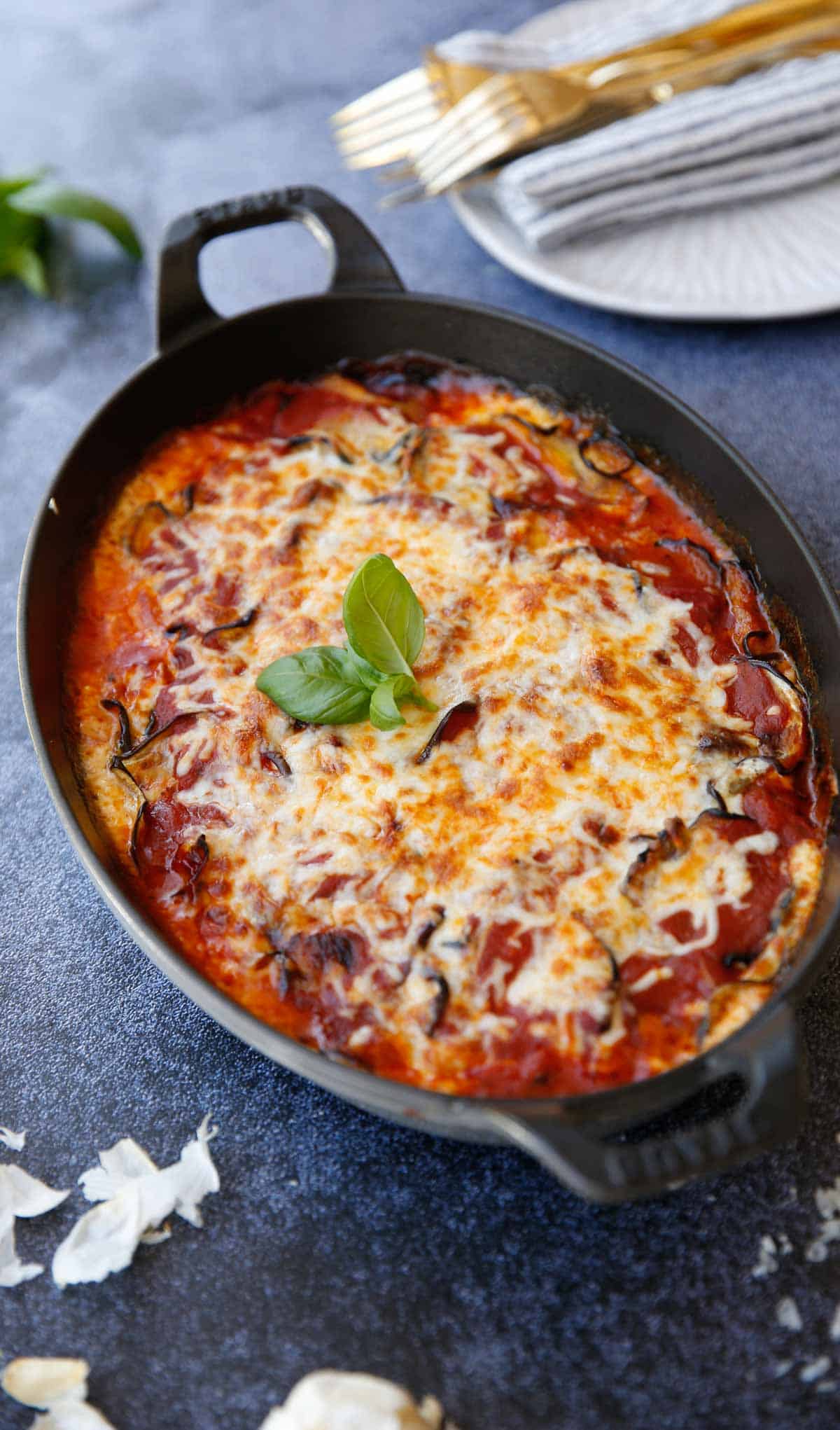 a gratin dish of baked eggplant parmesan