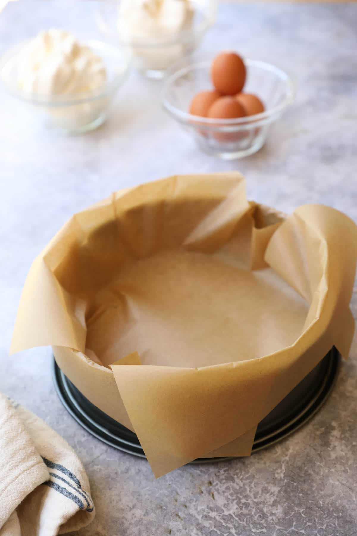 a springform pan lined with parchment paper linner