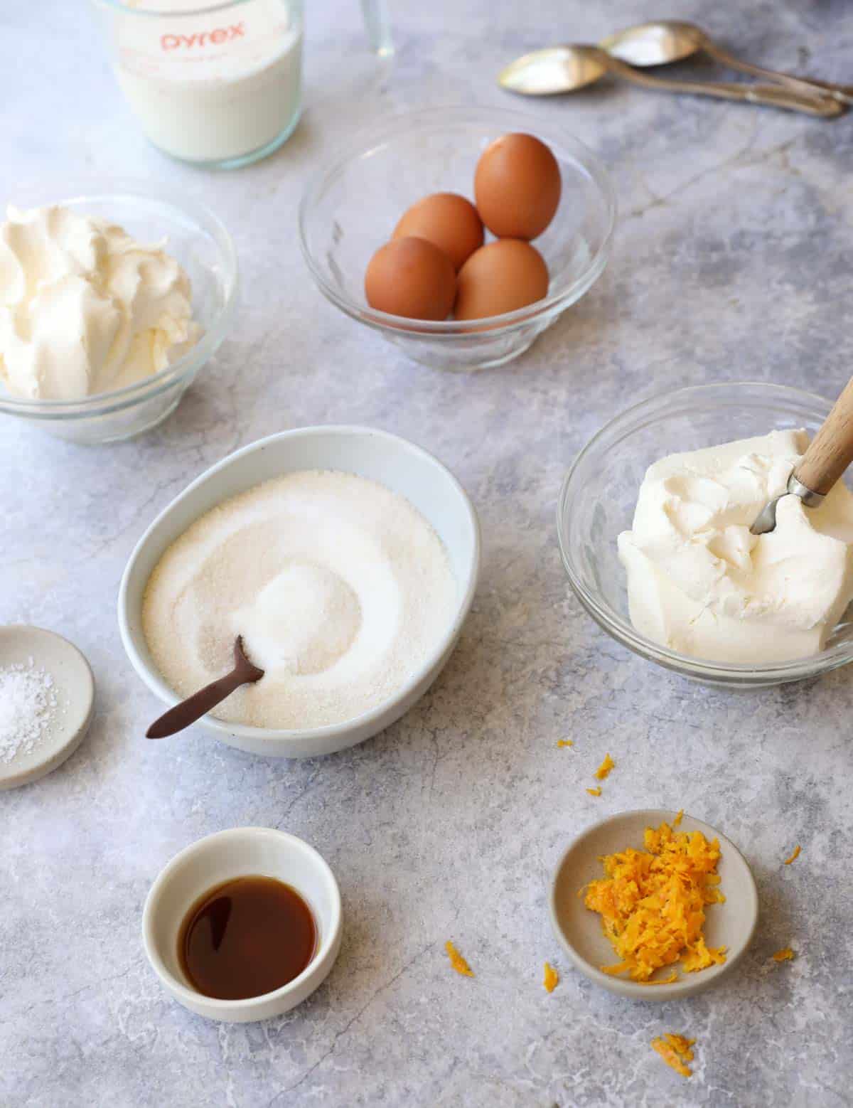 Ingredients laid out on a counter for making cheesecake