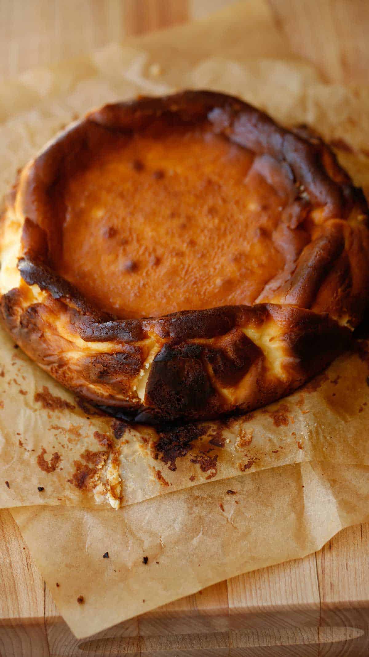 a burnt basque cheesecake unwrapped in parchment paper