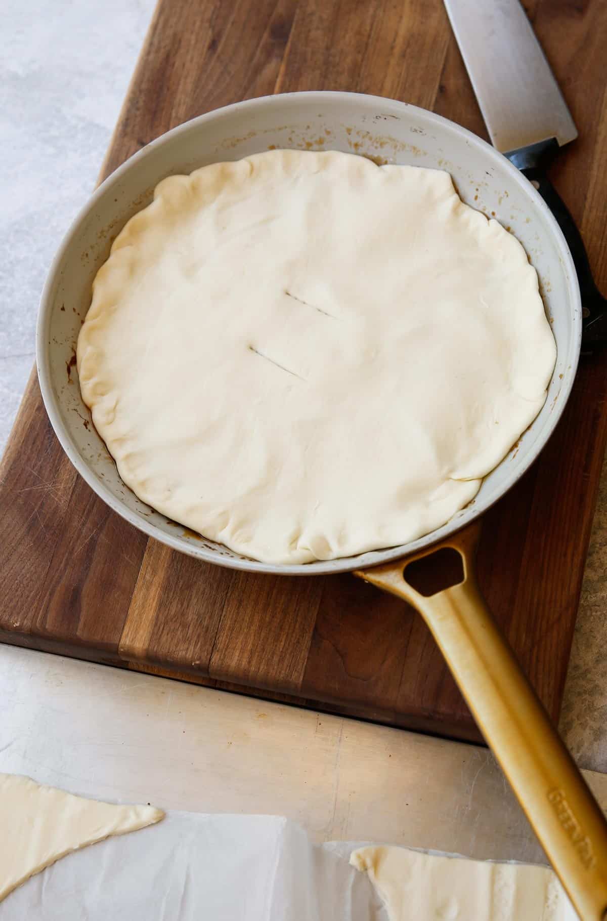 a skillet covered with a layer of puff pastry