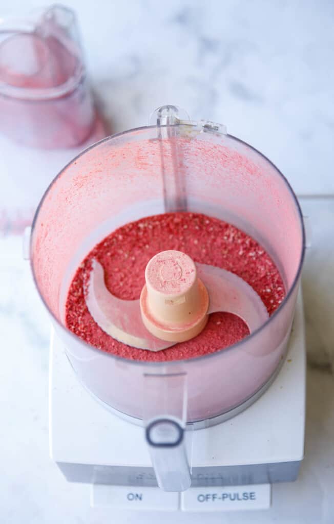 a food processor filled with strawberry dust