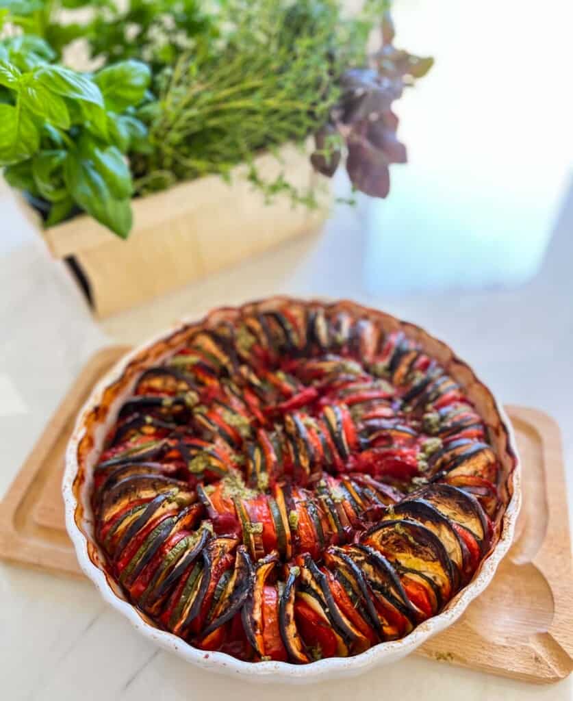 a Fully Baked Provencal Tian with Herb Basket in Background