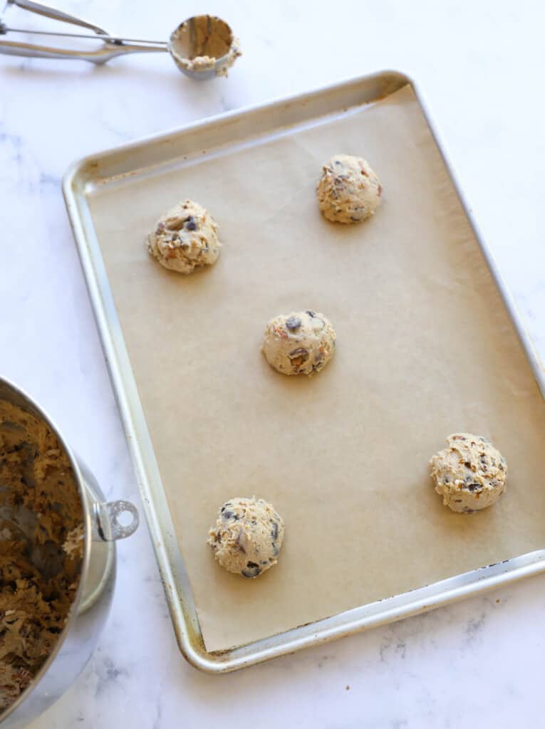 Balls of cookie dough on a sheet pan