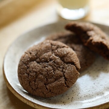 Chewy chocolate cookies on a plate with milk
