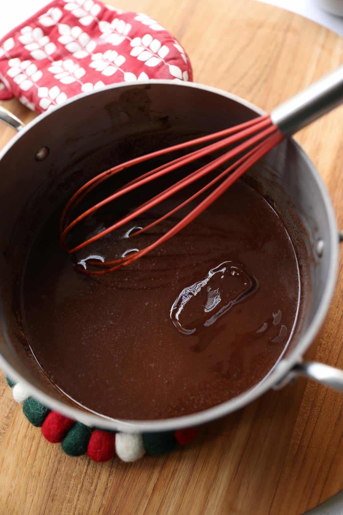 melted unsweetened chocolate in a large pot with whisk