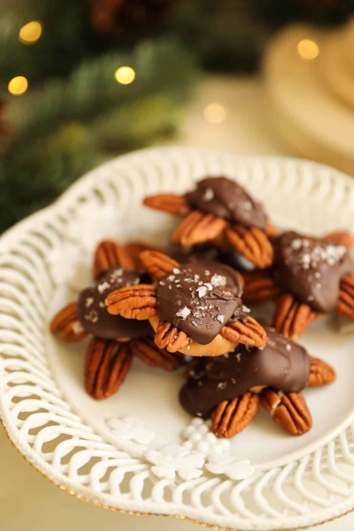 Chocolate turtles on a white candy dish