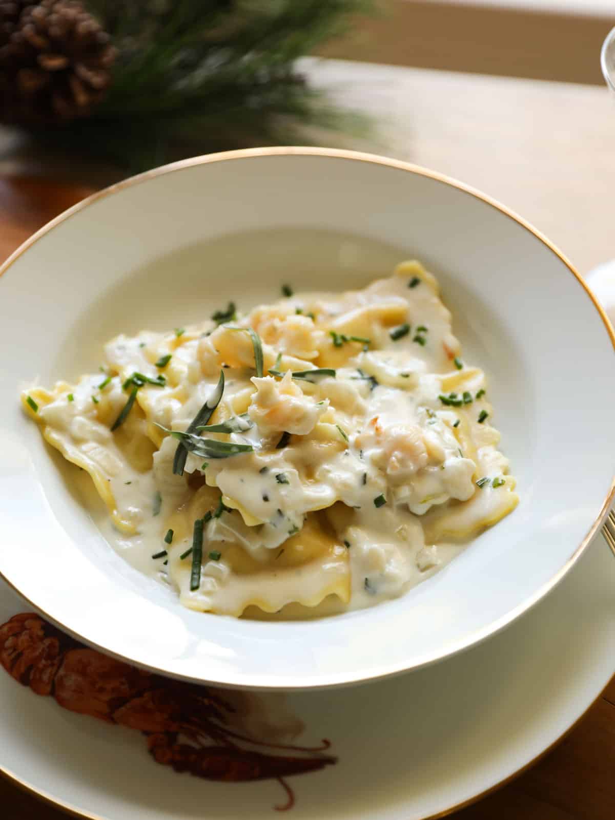 a bowl of lobster ravioli and a creamy sauce