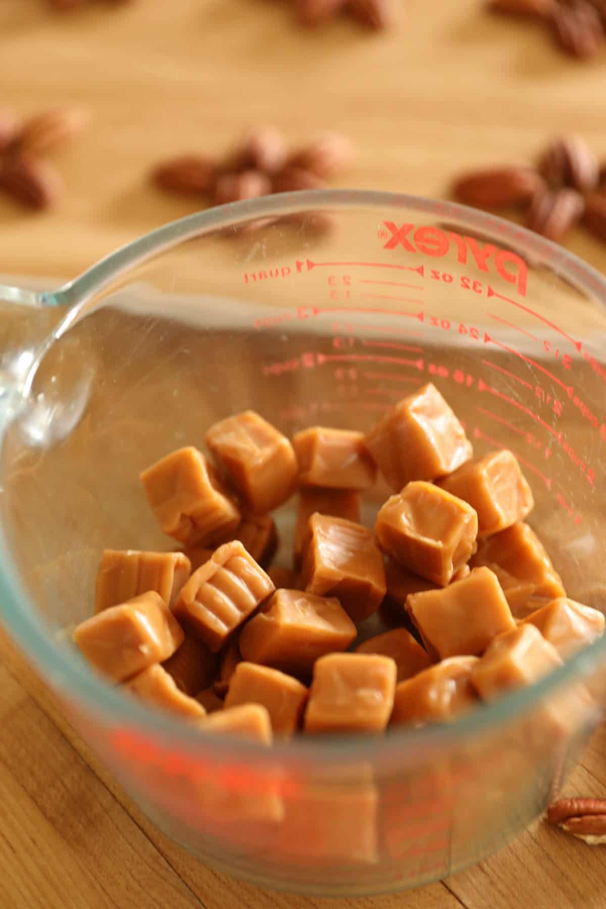 a bowl of softened Kraft Caramels in a clear bowl 