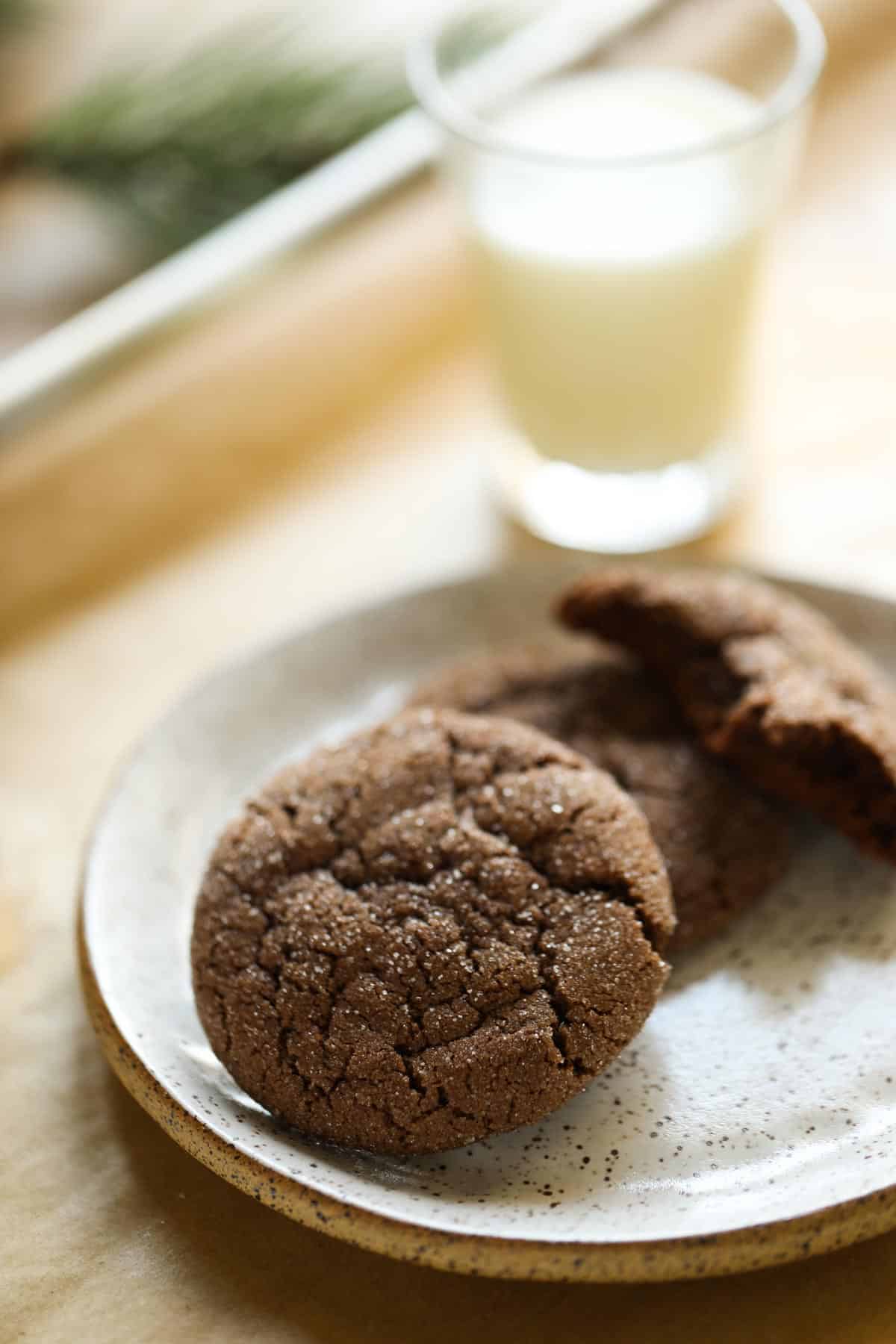 Two cracked chocolate cookies on a plate