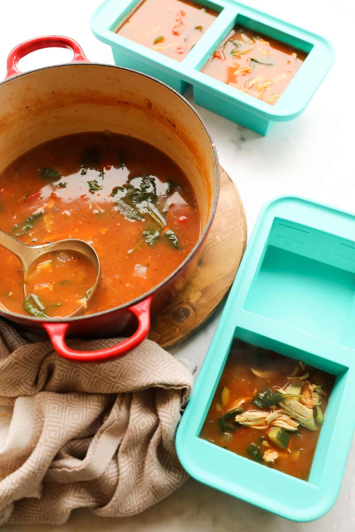 a pot of soup with souper cubes being filled