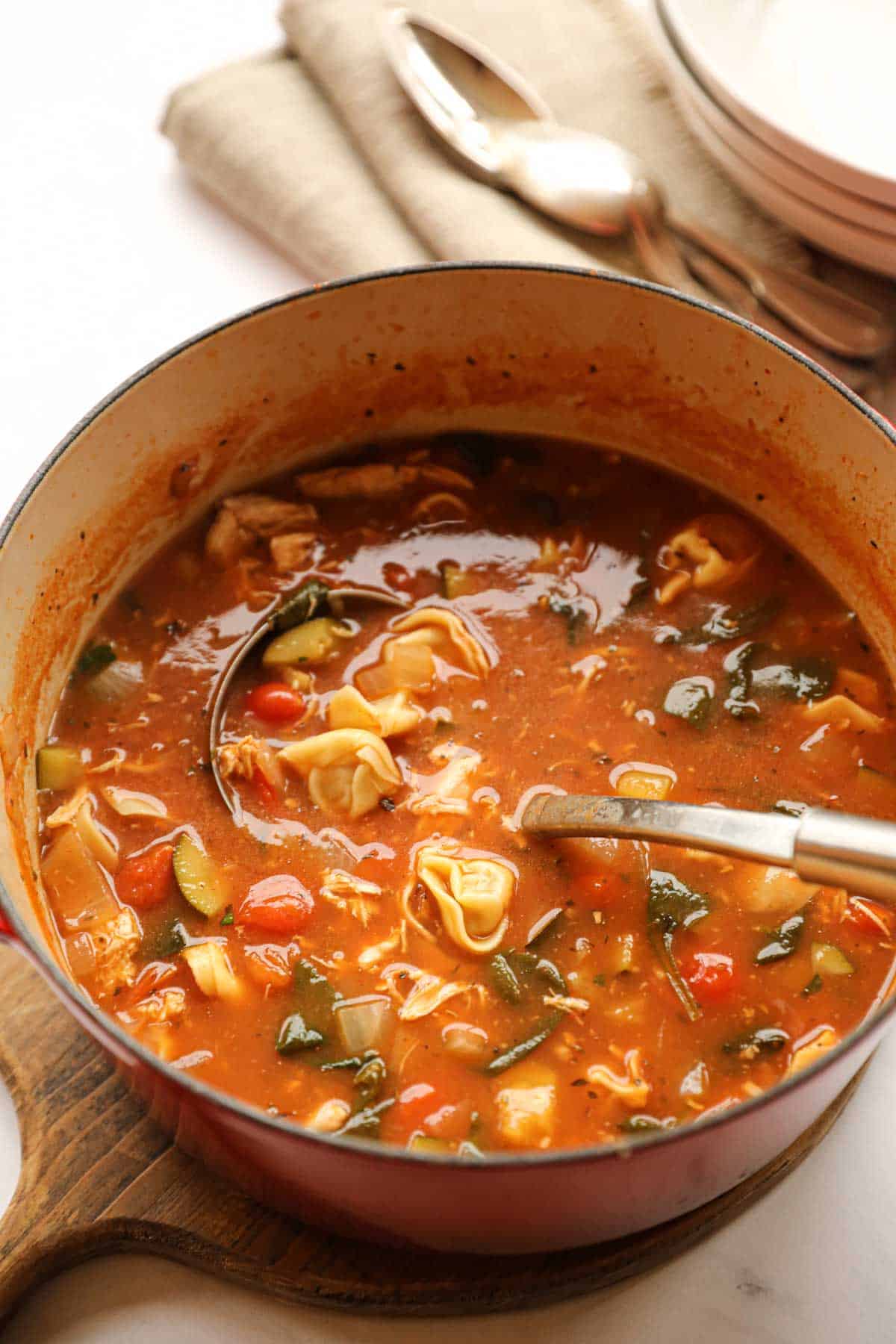 a large red pot of chicken tortellini soup