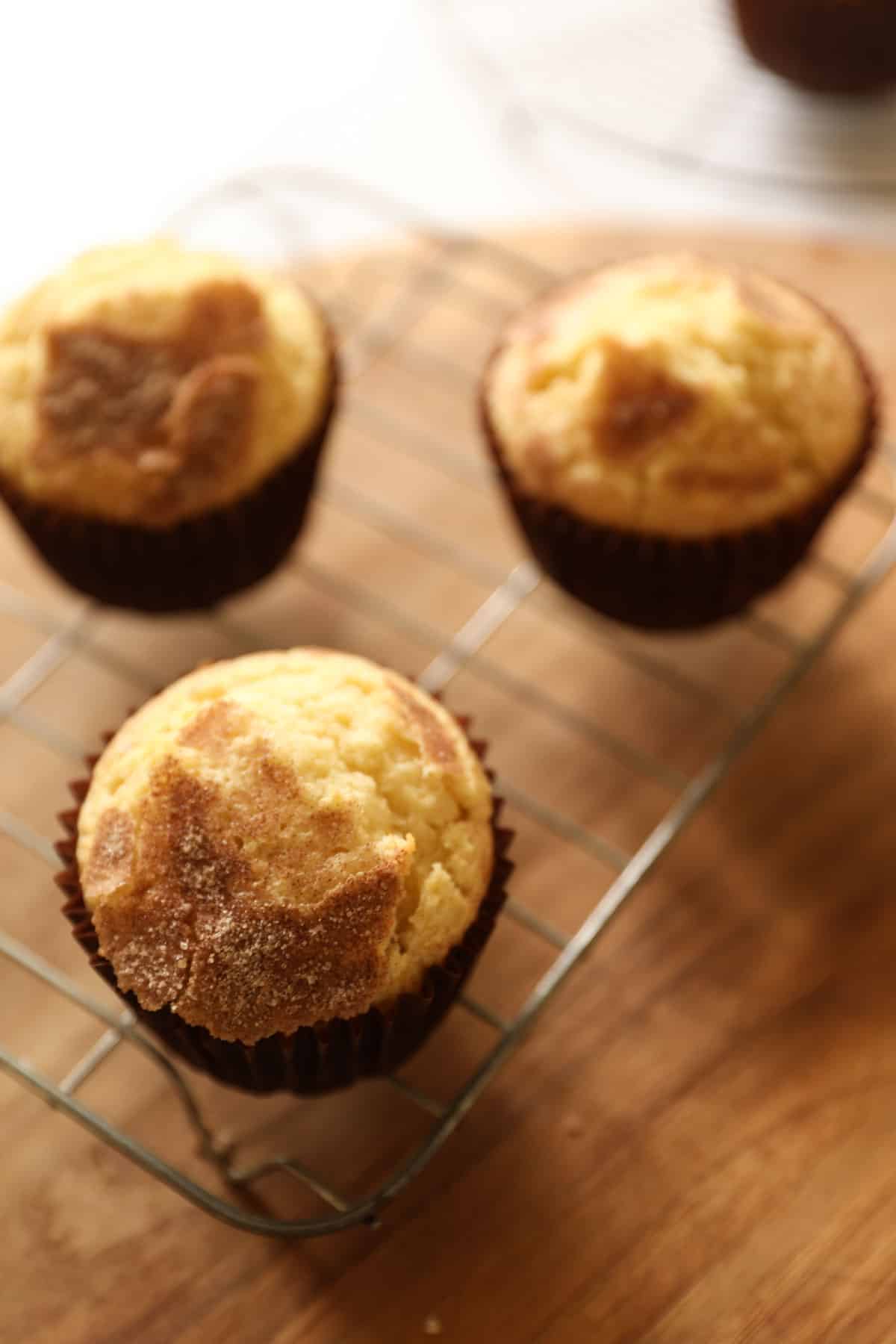 Snickerdoodle muffins on a cooling rack