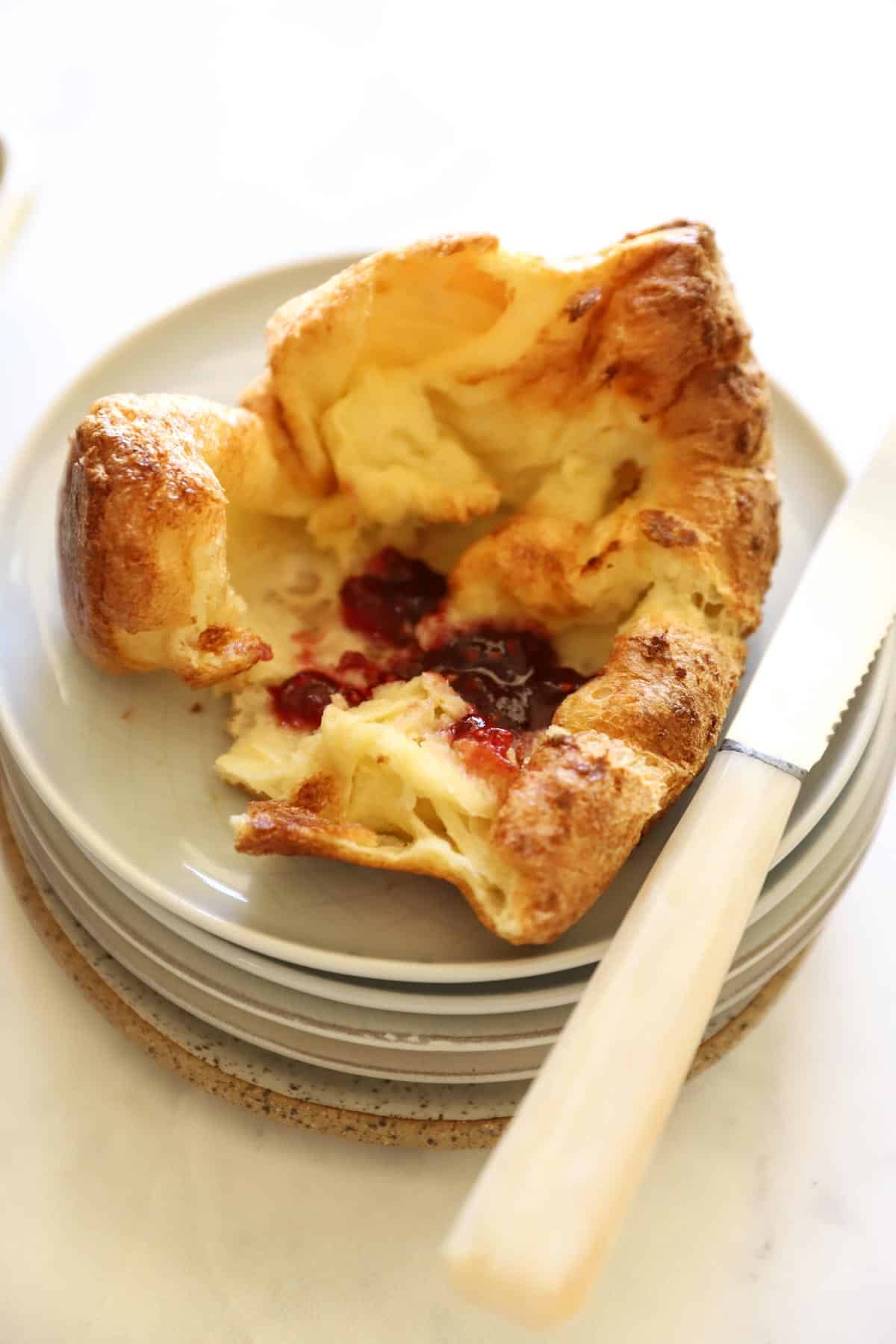 a popover on a plate with jam