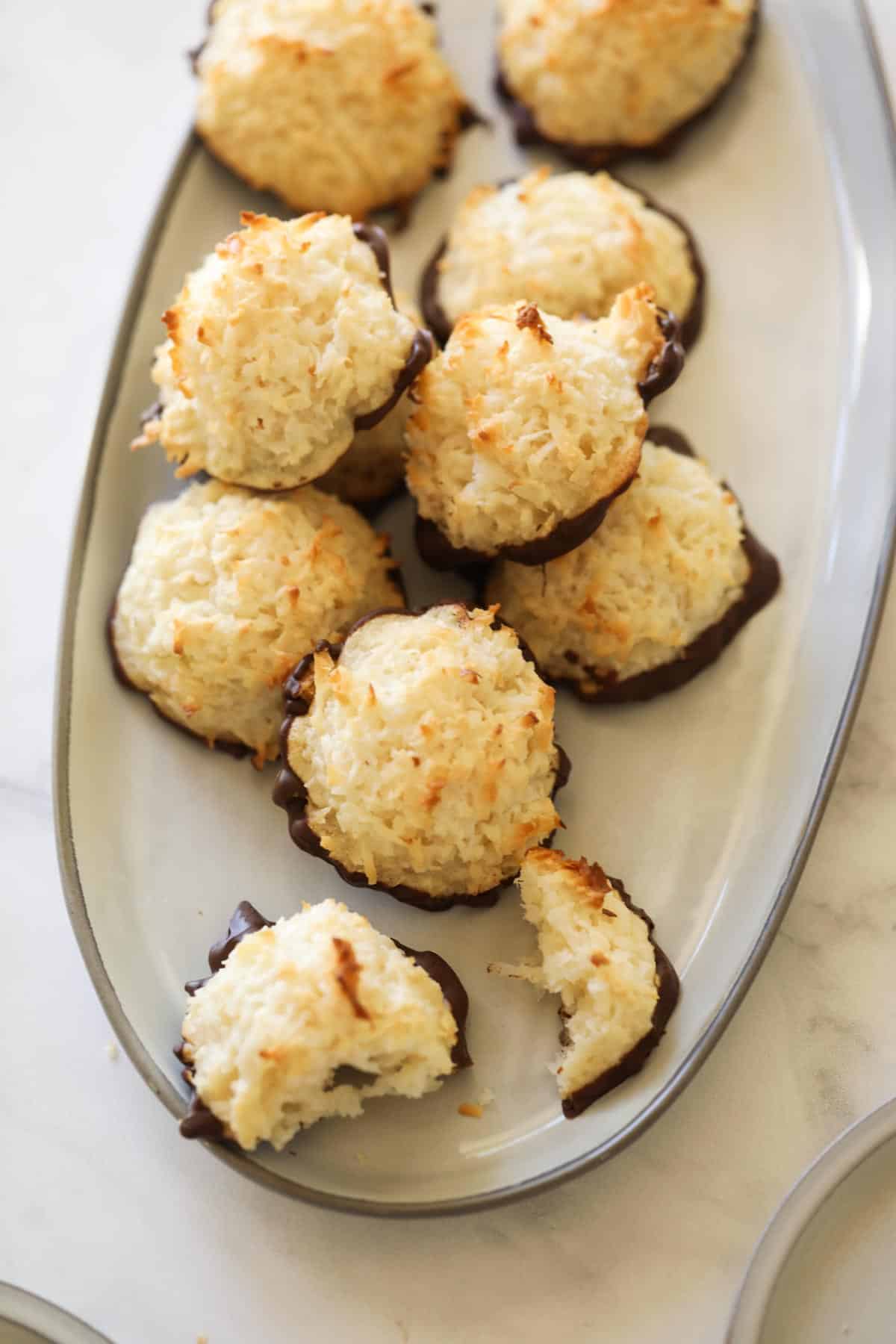 a platter of coconut cookies dipped in chocolate