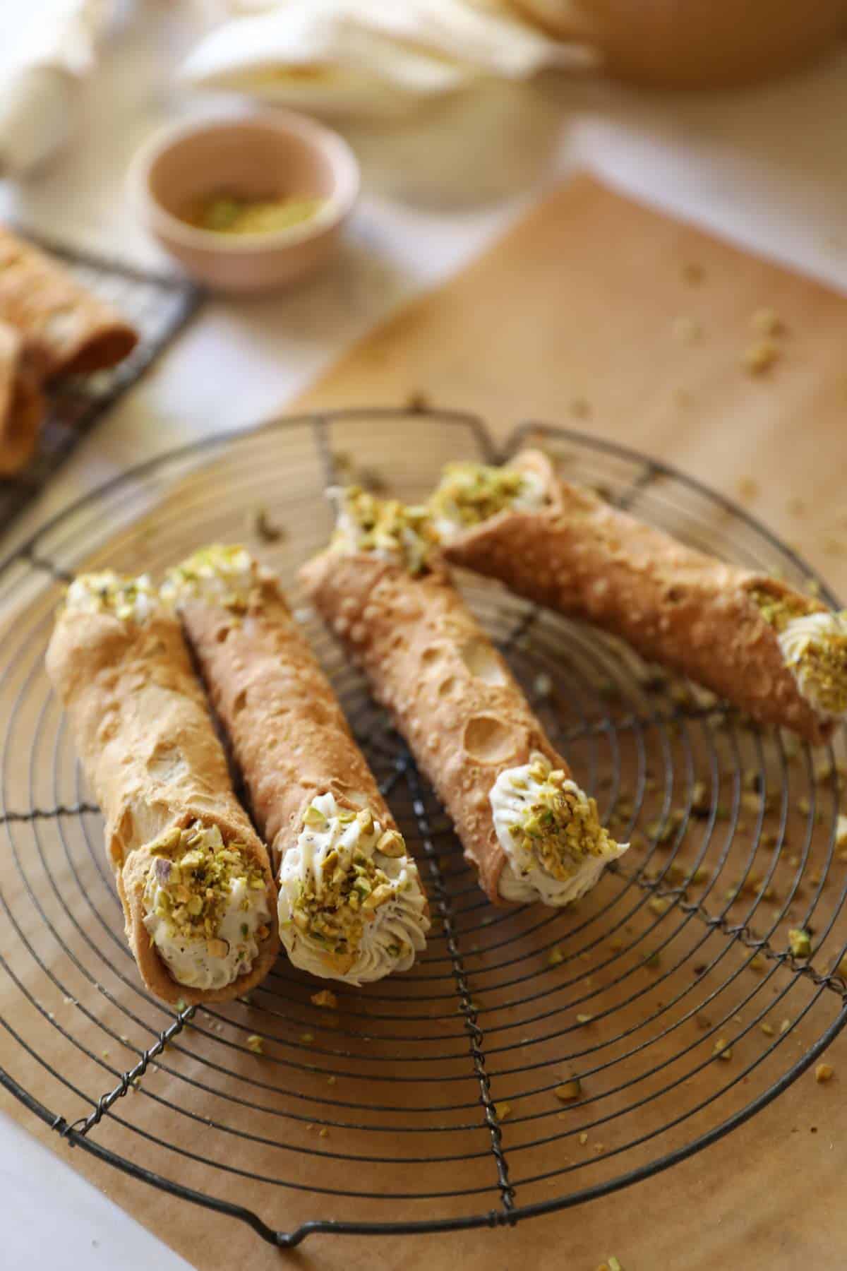 a station of cannoli shells being filled with ricotta cheese cannoli filling