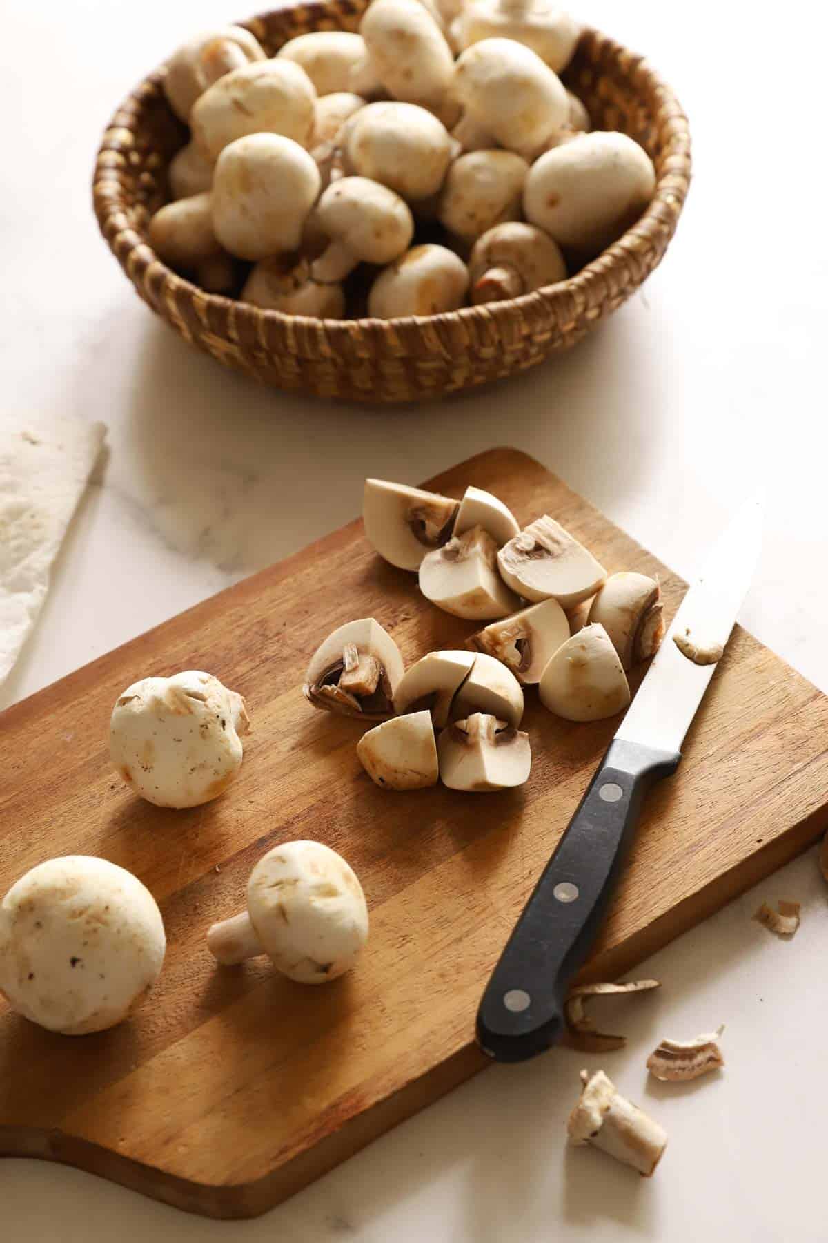 Quarter white button mushrooms for a hearty mushroom topping.