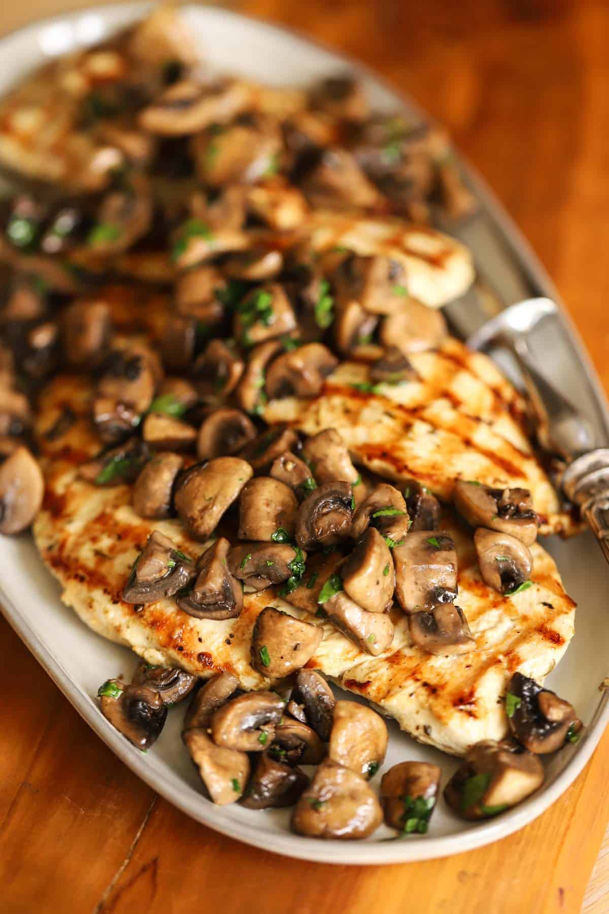 Grilled chicken topped with mushrooms