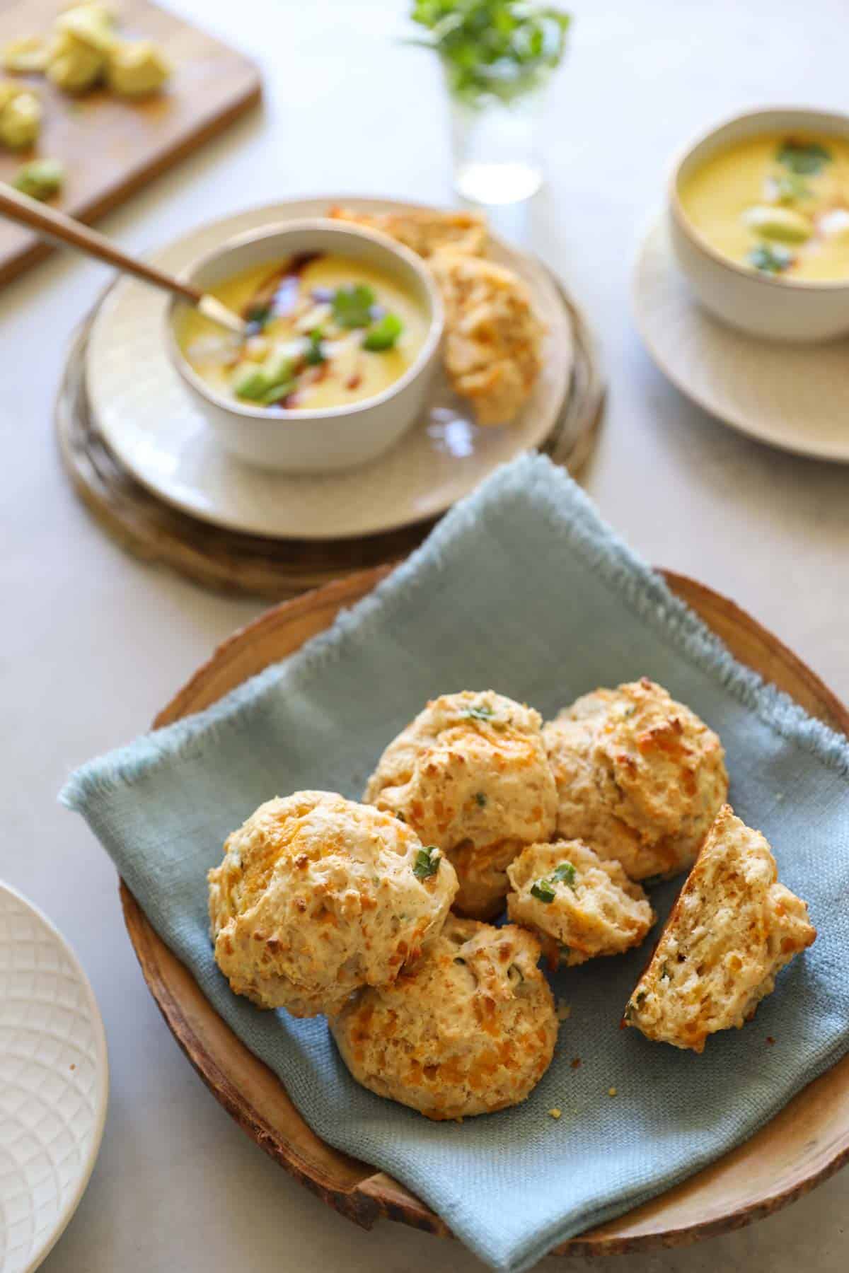 a scene of bowls of corn soup served with cheddar biscuits