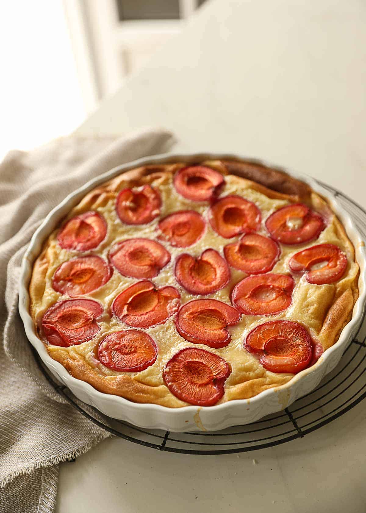 a clafoutis cooling on a counter.
