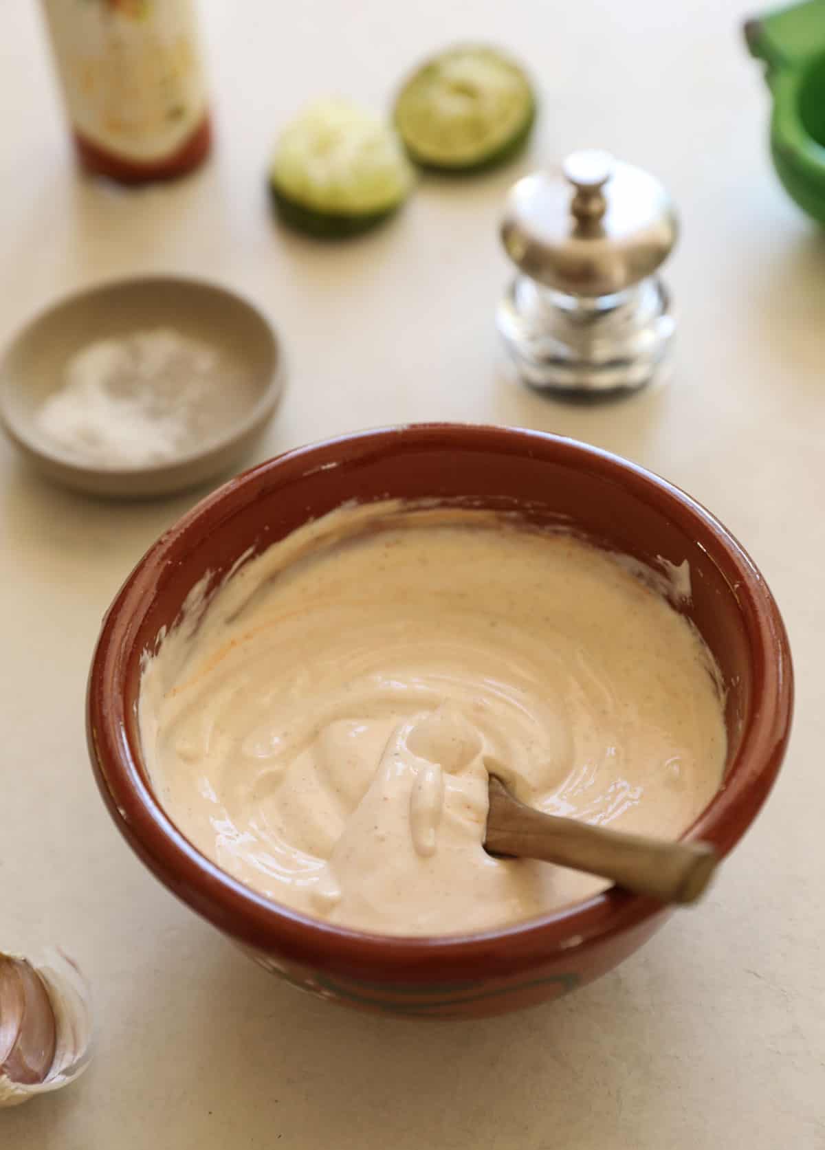 a fish taco sauce on a terra cotta bowl