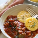 Chicken cacciatore with polenta cakes in a bowl