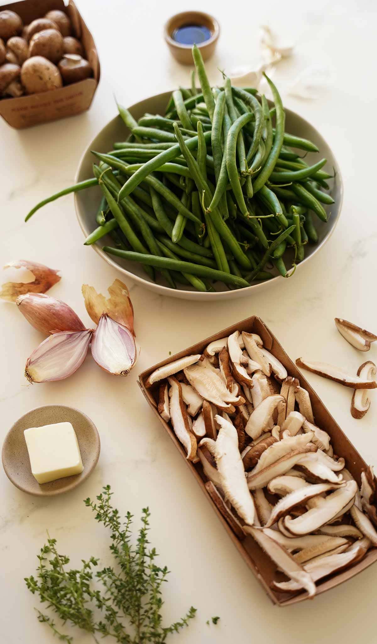 Fresh Green Beans, Mushrooms and other ingredients laid out on a counter