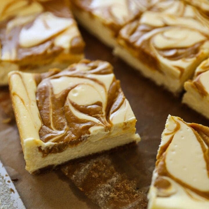 Pumpkin Cheesecake Bars sliced on board